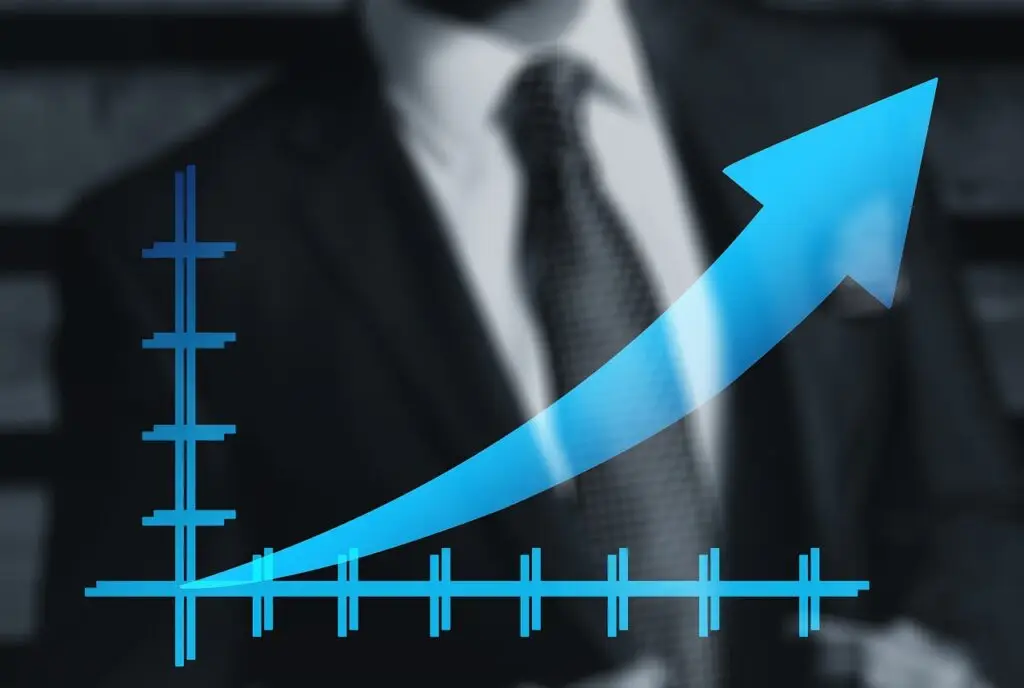 Image Oof a man in the background with an arrow point to the right and upwards in th foreground. The arrow is also shown on a graph.