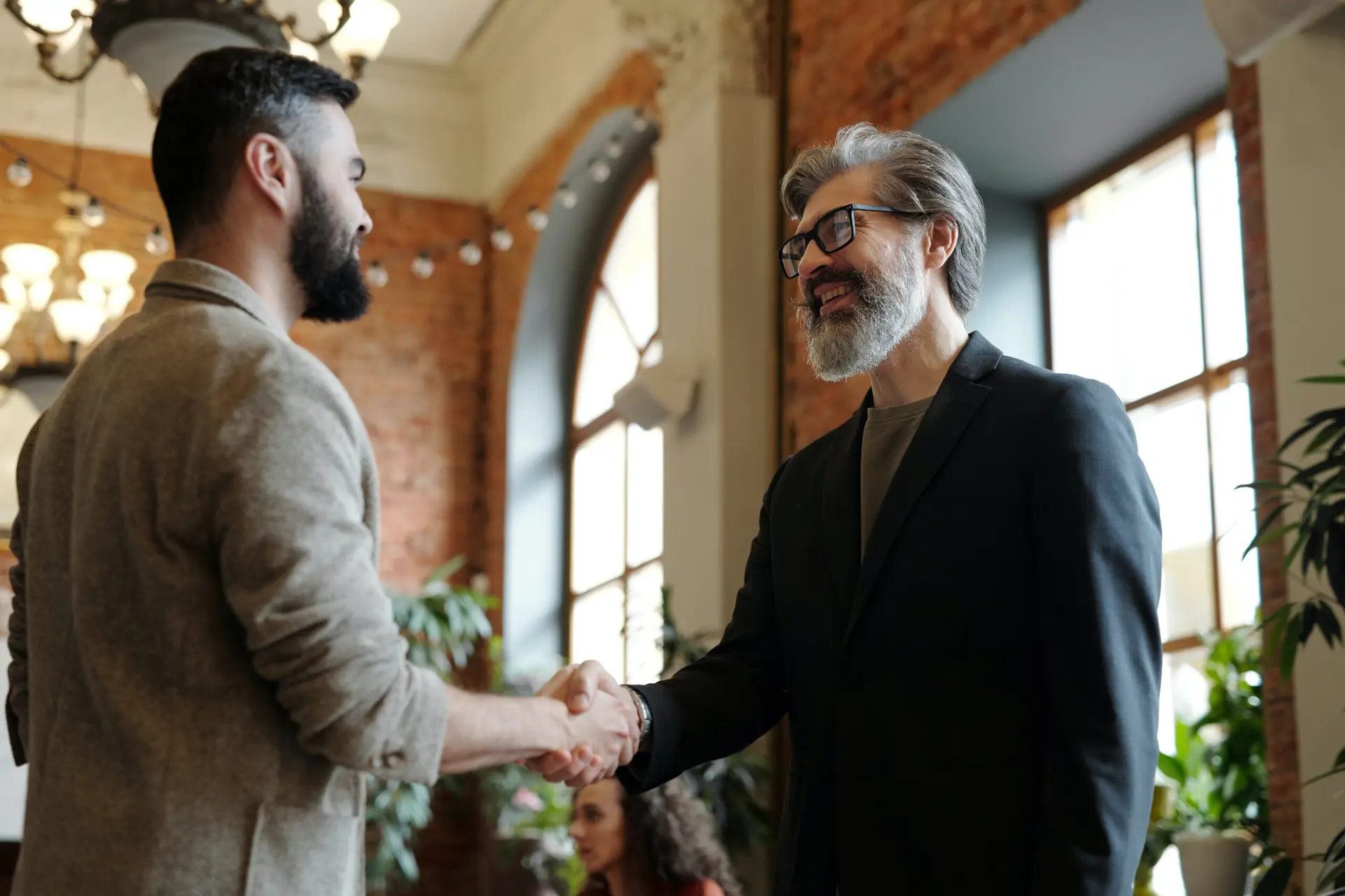 Two business men closing a deal with a handshake