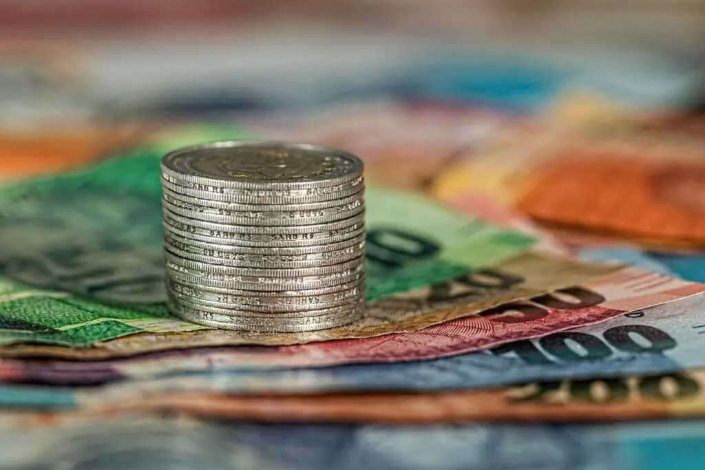 Image of stack of coins sitting on top of cash.