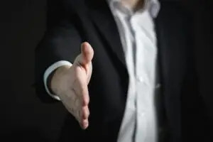 Man with hand out reaching for handshake