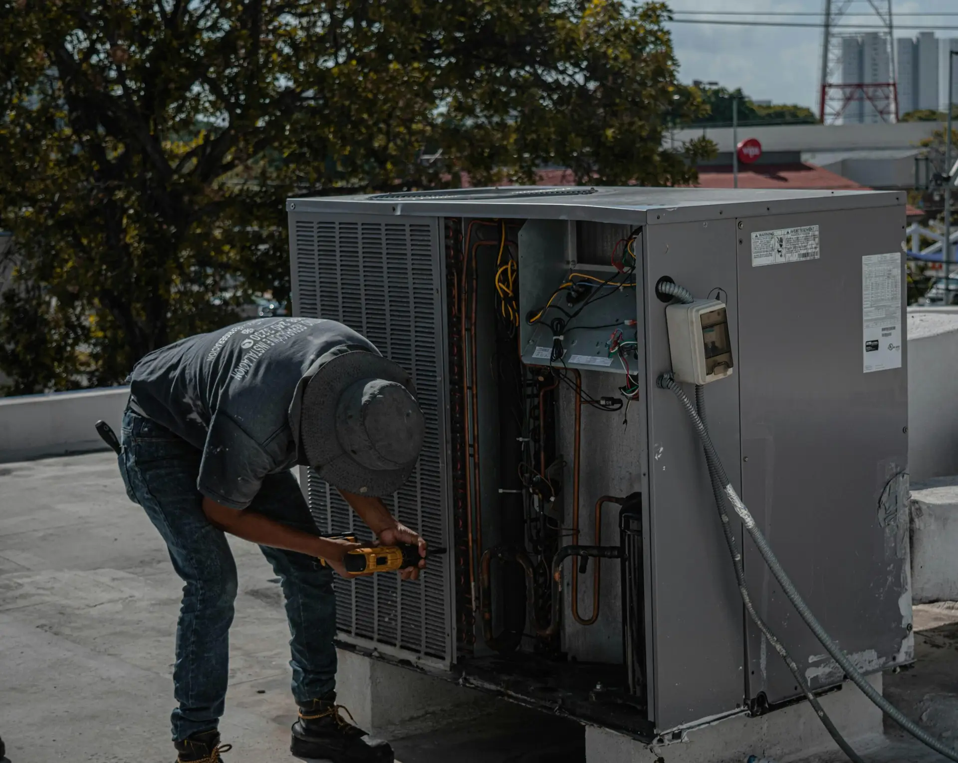 HVAC Tech working on a roof-top unit.