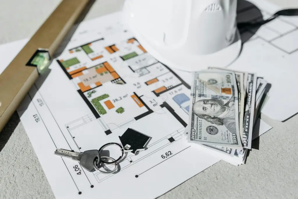 Residential Design Plans on Table with Hard Hat, Keys and Keys.