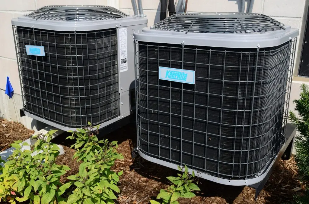 Two permanent residential AC units installed at a house.